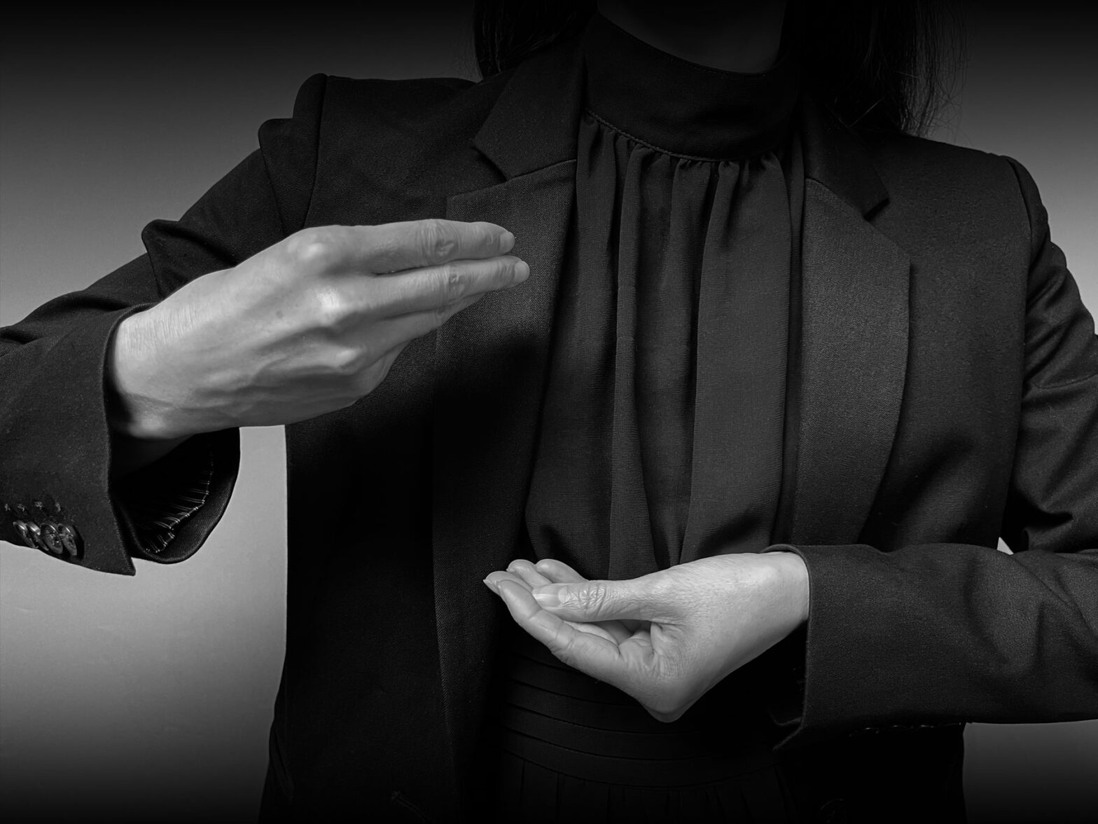 Woman with hands in front of her making the ASL sign for the concepts “lineage